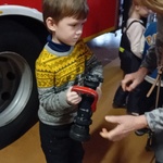 Dzieci mają okazję dotknąć części sprzętu strażackiego.jpg