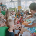 Pani wlewa wodę smakową do kubeczków dzieci.jpg