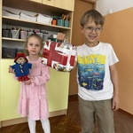 dzieci prezentują misia i walizkę