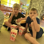 chłopcy jedzą popcorn